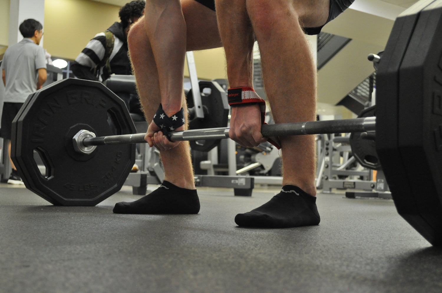 Image of a person performing a deadlift wearing our performance stink free socks